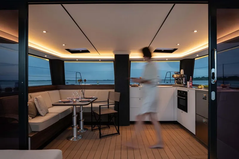  Yacht Photos Pics Luxurious interior of 2025 Vaan R4 yacht with modern kitchen and seating area.