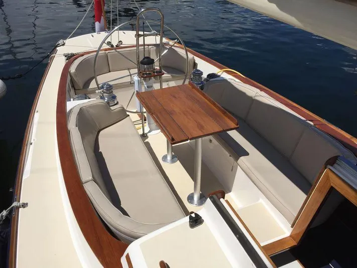 Ohana Lll Yacht Photos Pics 2009 Alerion Express 33 sailboat cockpit with wooden table and cushioned seating.