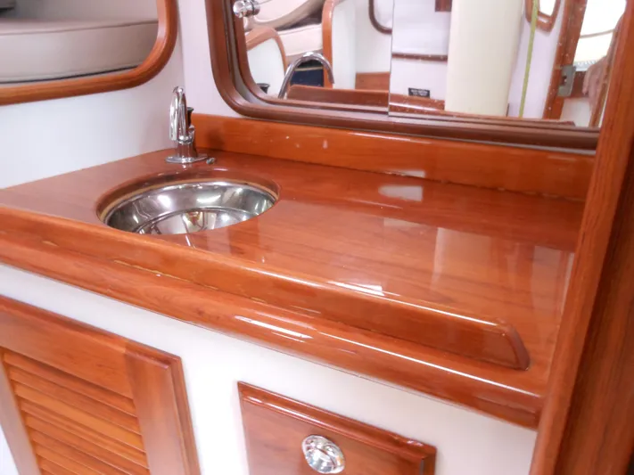 Ohana Lll Yacht Photos Pics 2009 Alerion Express 33 yacht interior with polished wood countertop and stainless steel sink.
