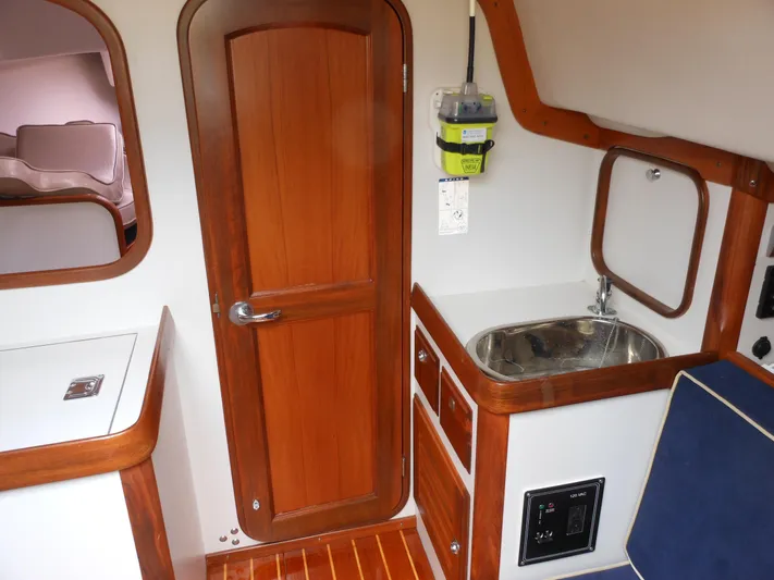 Ohana Lll Yacht Photos Pics 2009 Alerion Express 33 interior with wooden door, sink, and cabinetry.