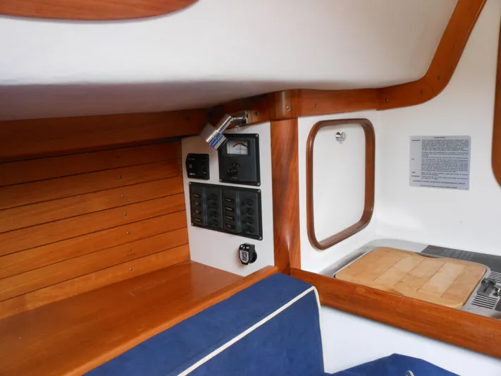 Ohana Lll Yacht Photos Pics Interior of 2009 Alerion Express 33 sailboat with control panel and wooden accents.