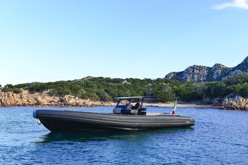 Black Shiver 120 Efb Yacht Photos Pics 2025 Novamarine Black Shiver 120 Diesel boat on serene water with rocky shoreline backdrop.
