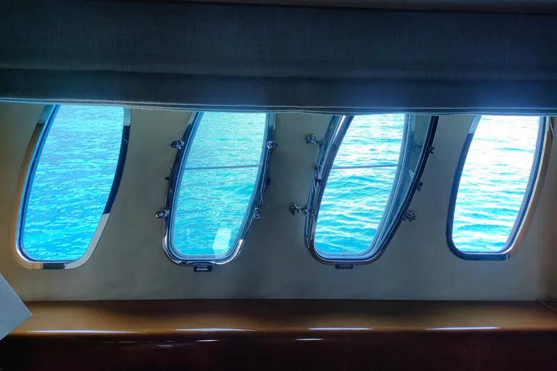  Yacht Photos Pics Interior view through Sunseeker 82 Yacht windows, showcasing serene blue ocean, 2004 model.