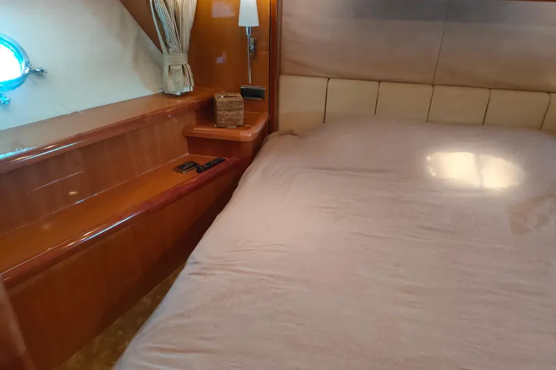  Yacht Photos Pics Luxurious bedroom interior of 2004 Sunseeker 82 Yacht with elegant wood finish.