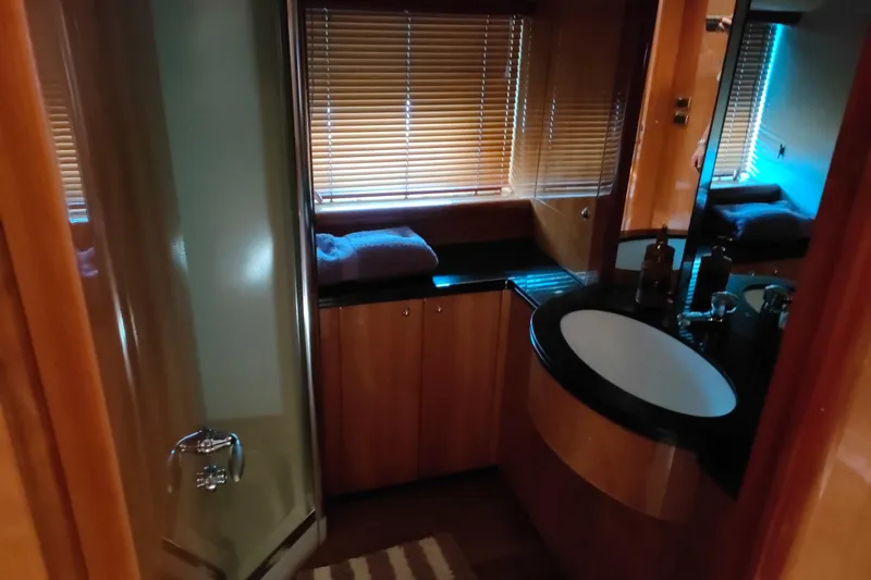  Yacht Photos Pics Luxurious bathroom interior of 2004 Sunseeker 82 Yacht with modern fixtures.