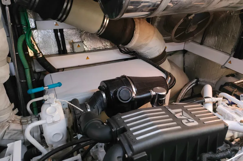  Yacht Photos Pics Engine room of a 2004 Sunseeker 82 Yacht, featuring CAT machinery and insulated pipes.