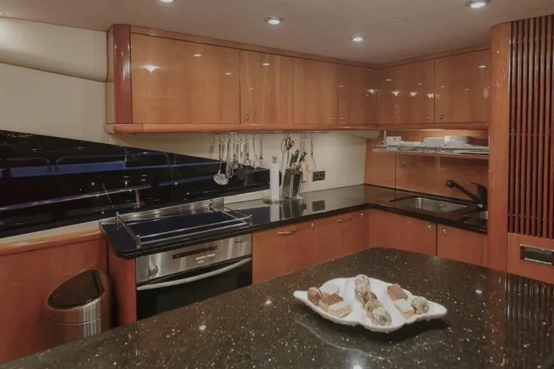  Yacht Photos Pics Luxurious kitchen interior of 2004 Sunseeker 82 Yacht with modern appliances and elegant wood cabinetry.