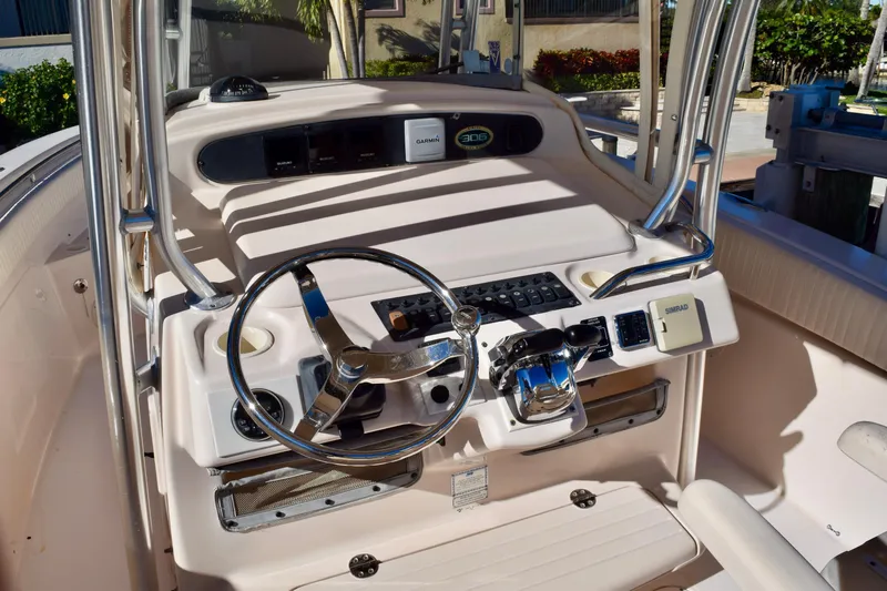  Yacht Photos Pics 2006 Grady-White Bimini 306 boat console with steering wheel and navigation equipment.
