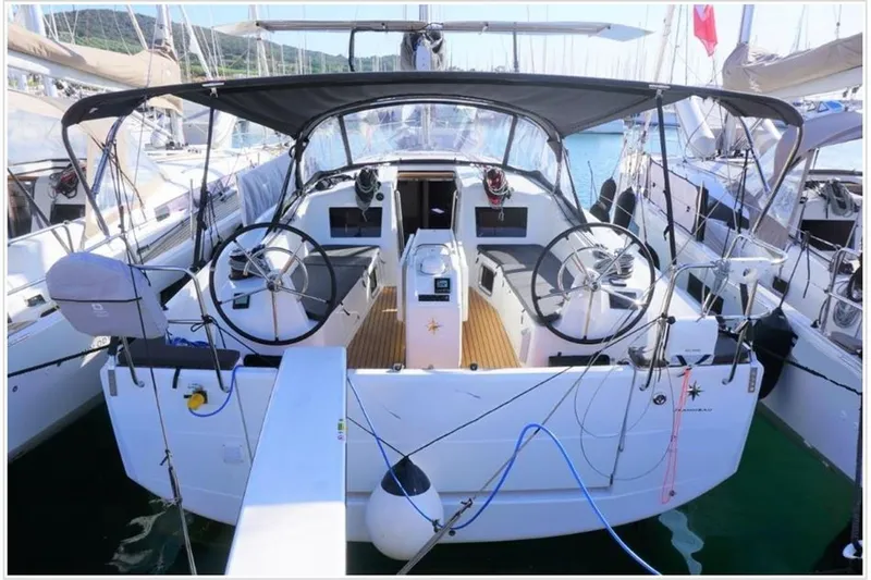  Yacht Photos Pics 2022 Jeanneau Sun Odyssey 410 sailboat with dual steering wheels, docked in a marina.