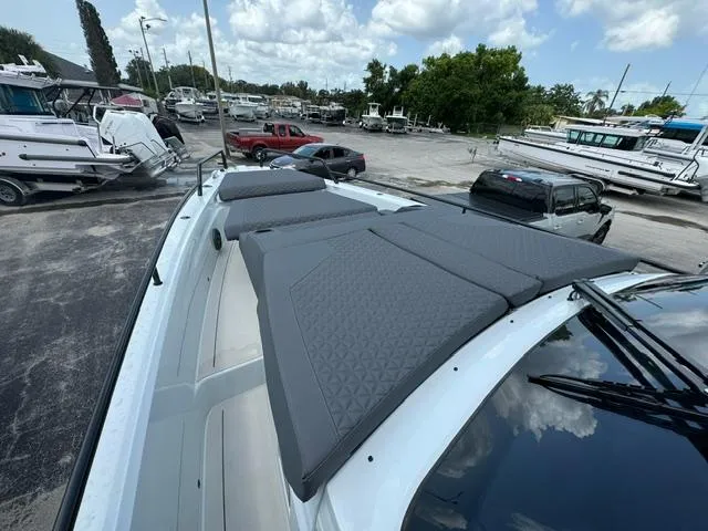  Yacht Photos Pics 2024 BRABUS Shadow 1000 ST boat with cushioned deck, parked in a marina.