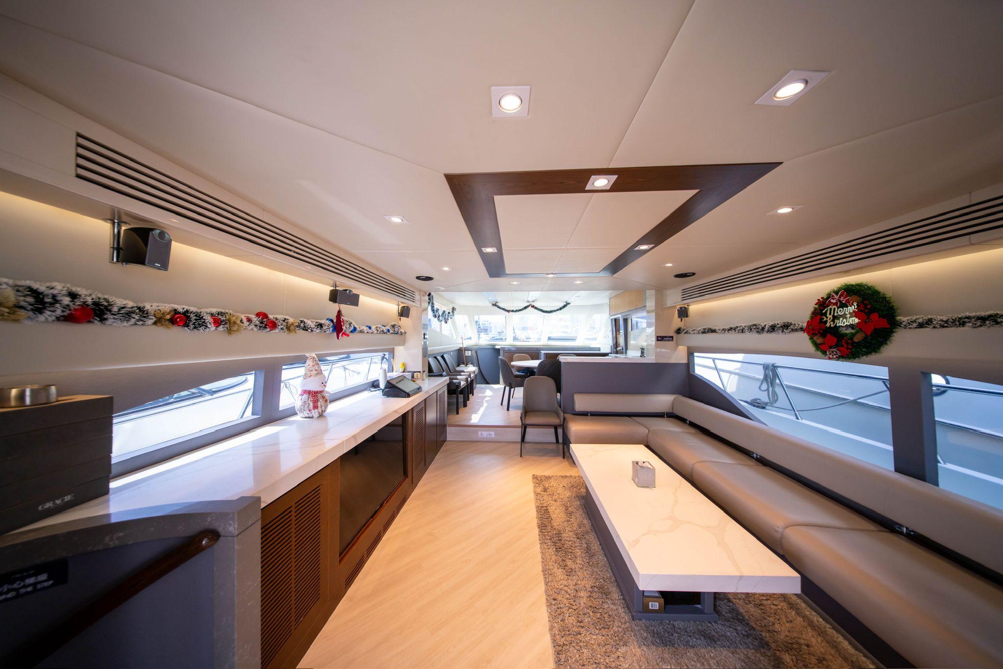 Luxurious interior of a 2011 Ruby 68 yacht, featuring modern decor and festive decorations.