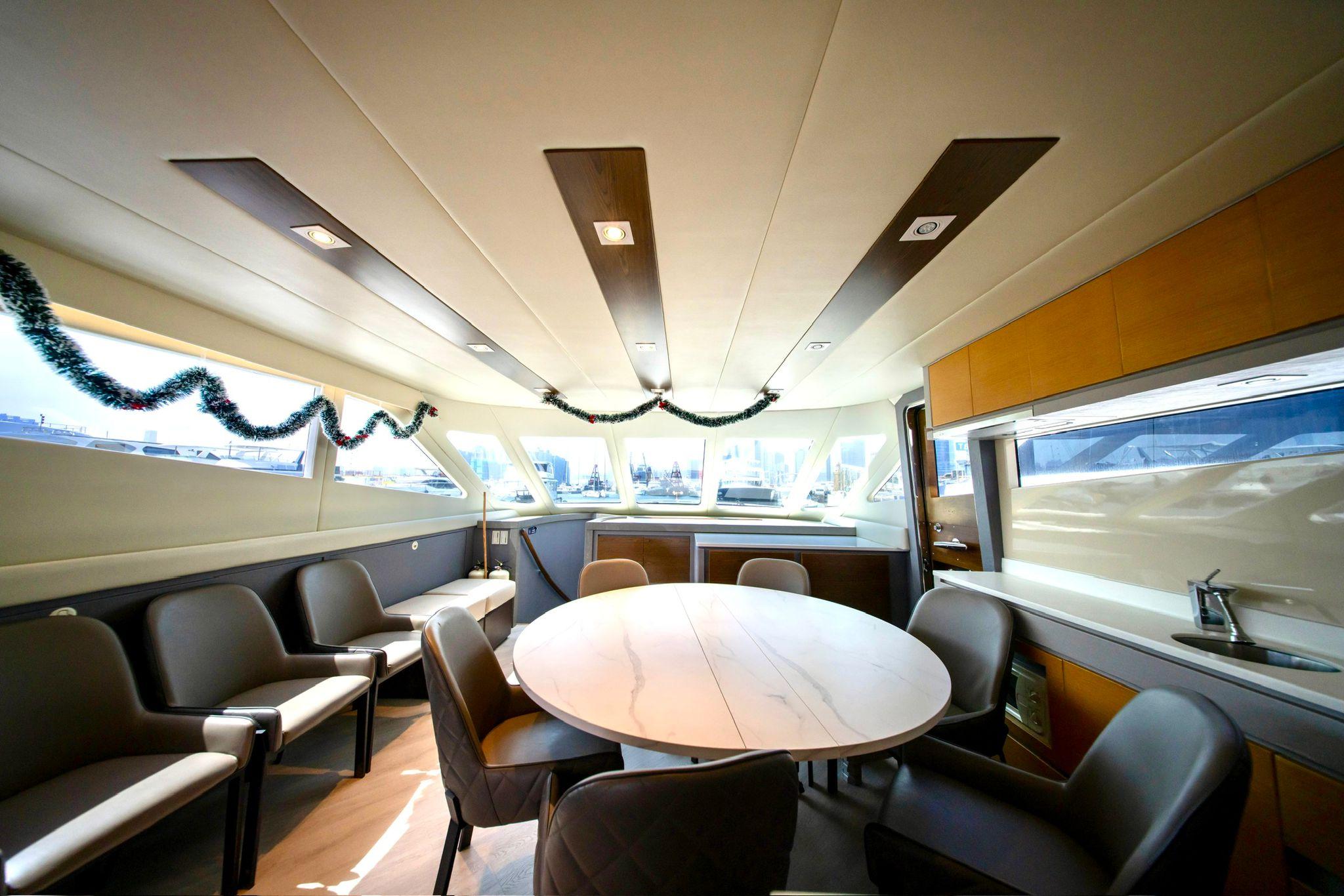 Luxurious Ruby 68 yacht interior, 2011 model, featuring elegant seating and a round table.