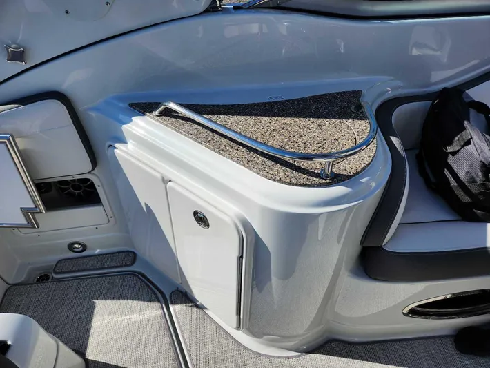  Yacht Photos Pics 2024 Crownline 280 CRX boat interior with storage compartment and seating.