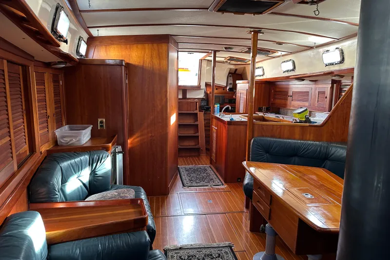 Braveheart Yacht Photos Pics Interior of a 1999 Tartan 4600 yacht with wooden furnishings and leather seating.