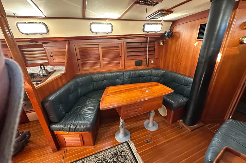 Braveheart Yacht Photos Pics Luxurious 1999 Tartan 4600 yacht interior with wood paneling and leather seating.