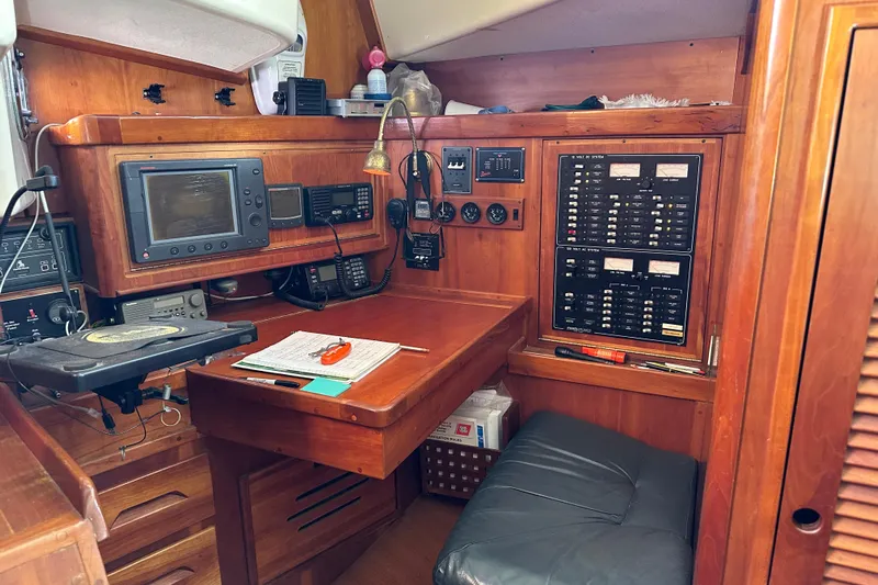 Braveheart Yacht Photos Pics Navigation station inside a 1999 Tartan 4600 yacht with control panels and equipment.
