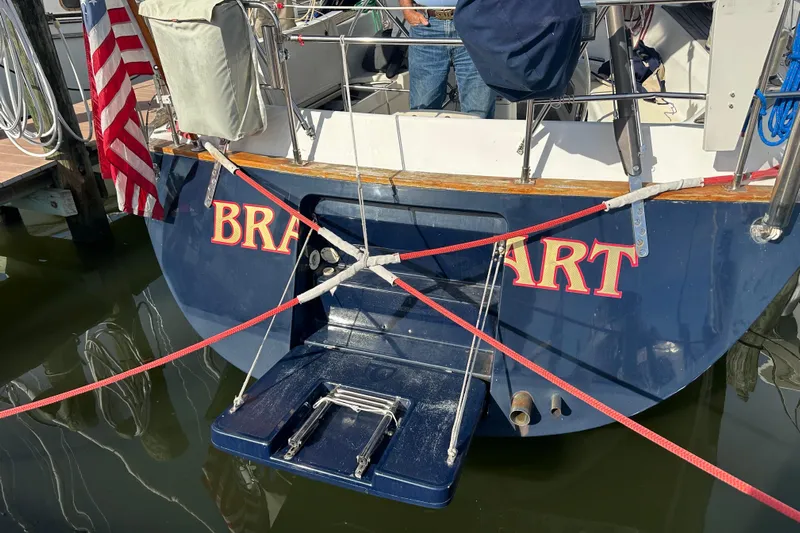 Braveheart Yacht Photos Pics Sailboat stern with American flag, Tartan 4600, 1999 model, docked at marina.