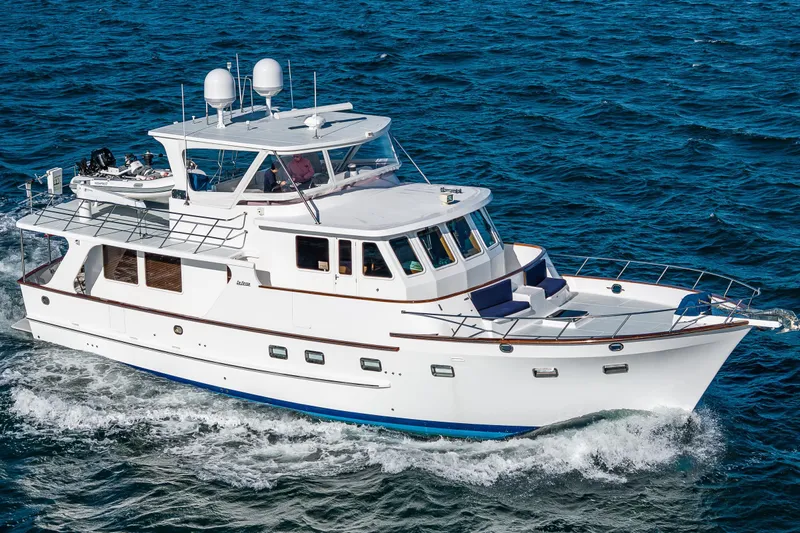 Flyin Low Yacht Photos Pics 2007 DeFever 56 yacht cruising on open sea, showcasing elegant design and spacious deck.