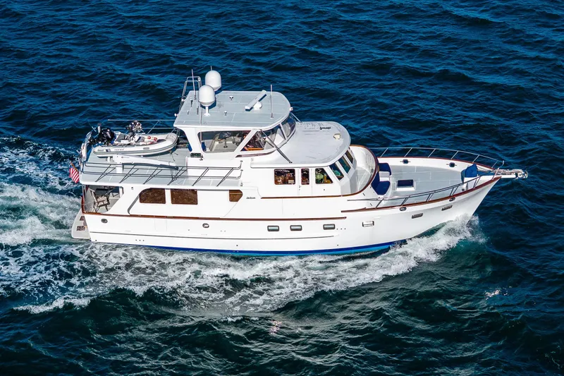 Flyin Low Yacht Photos Pics Aerial view of 2007 DeFever 56 yacht cruising on open water.