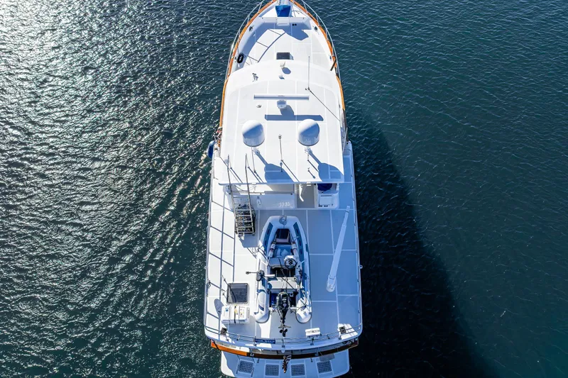 Flyin Low Yacht Photos Pics Aerial view of 2007 DeFever 56 yacht on calm water.