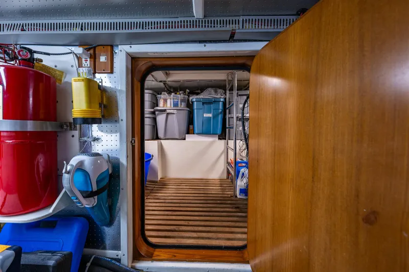 Flyin Low Yacht Photos Pics Engine room of 2007 DeFever 56 yacht with storage bins and equipment.