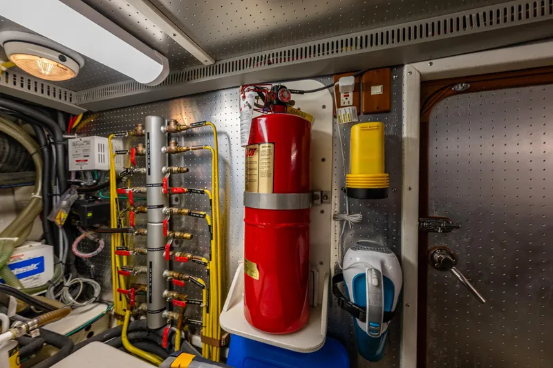 Flyin Low Yacht Photos Pics Engine room of 2007 DeFever 56 yacht with fire extinguisher and equipment.