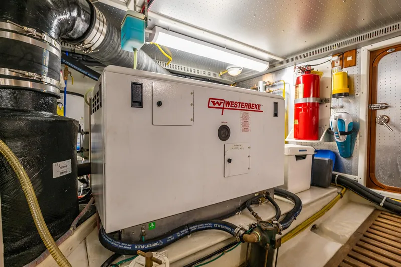 Flyin Low Yacht Photos Pics Engine room of 2007 DeFever 56 yacht featuring Westerbeke generator and safety equipment.