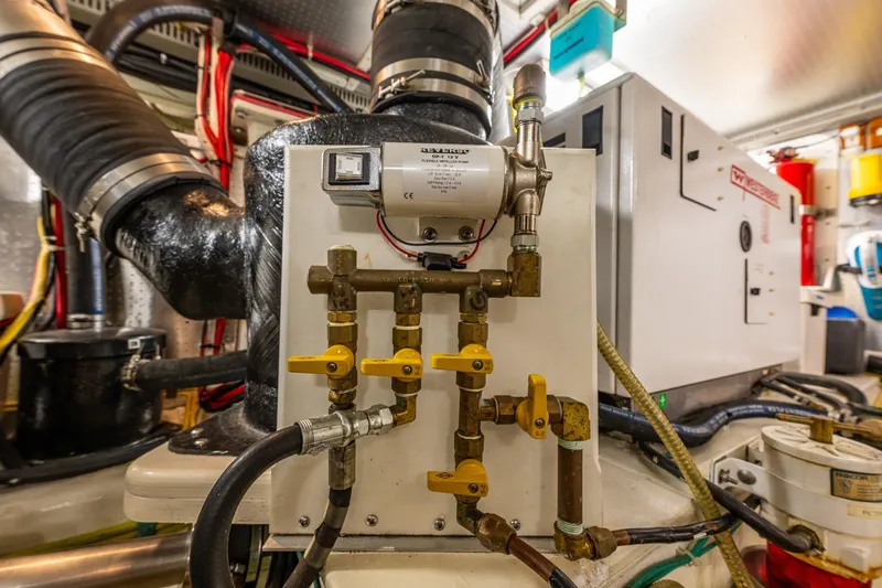 Flyin Low Yacht Photos Pics Engine room of 2007 DeFever 56 yacht with complex piping and machinery.