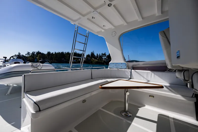 Flyin Low Yacht Photos Pics 2007 DeFever 56 yacht interior with seating area and table, overlooking scenic water view.