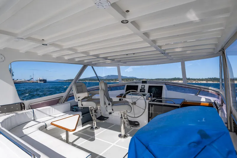 Flyin Low Yacht Photos Pics 2007 DeFever 56 yacht interior with helm, seating, and ocean view.