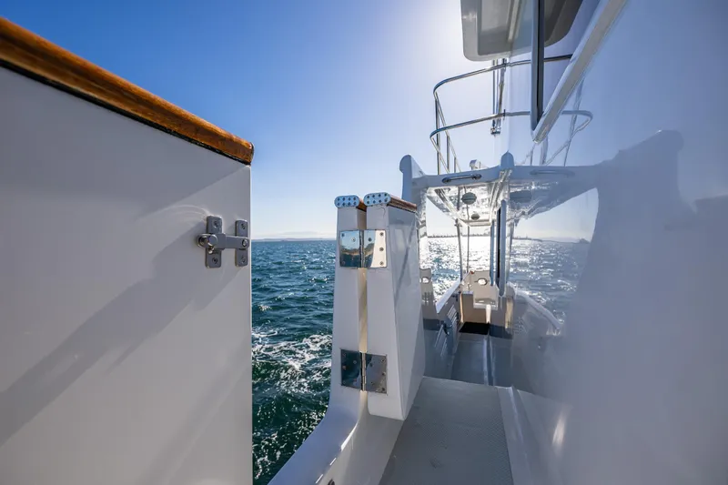 Flyin Low Yacht Photos Pics Side view of 2007 DeFever 56 yacht on open water, under clear blue sky.