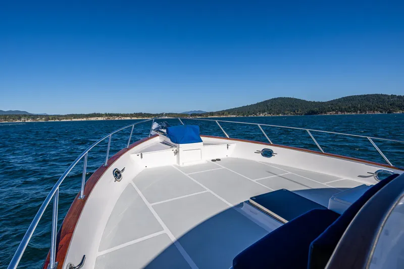 Flyin Low Yacht Photos Pics Bow view of 2007 DeFever 56 yacht cruising on a clear, sunny day.