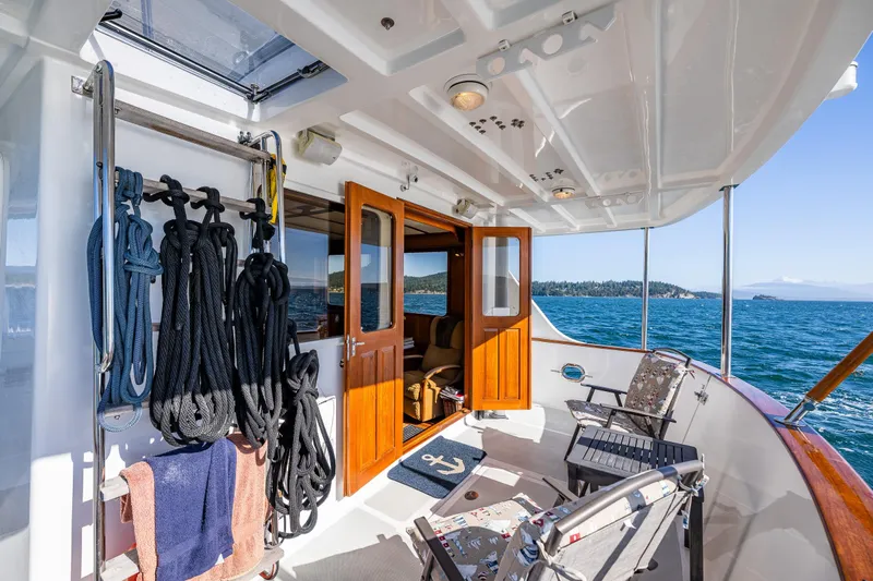 Flyin Low Yacht Photos Pics DeFever 56 yacht deck, 2007 model, with seating, ropes, and ocean view.