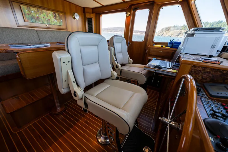 Flyin Low Yacht Photos Pics Luxurious 2007 DeFever 56 yacht interior with plush seating and navigation equipment.