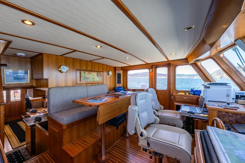 Flyin Low Yacht Photos Pics Luxurious 2007 DeFever 56 yacht interior with wood paneling and ocean view.