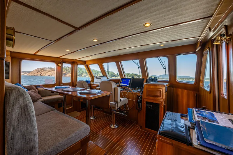 Flyin Low Yacht Photos Pics Luxurious 2007 DeFever 56 yacht interior with panoramic windows and elegant wood finish.