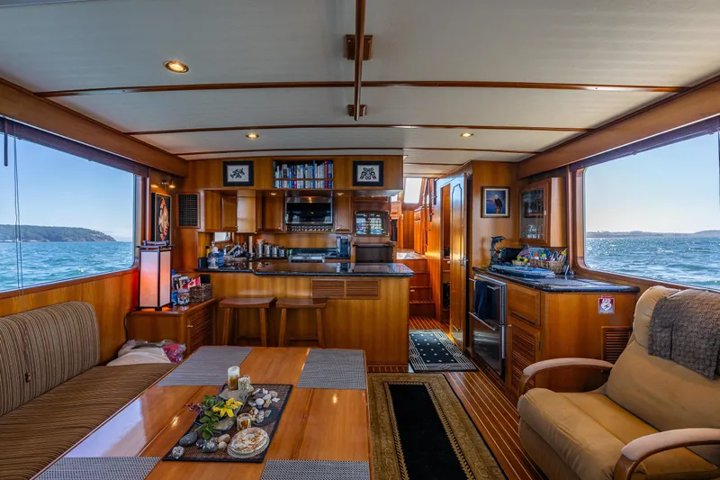 Flyin Low Yacht Photos Pics Luxurious 2007 DeFever 56 yacht interior with elegant wood finishes and ocean views.