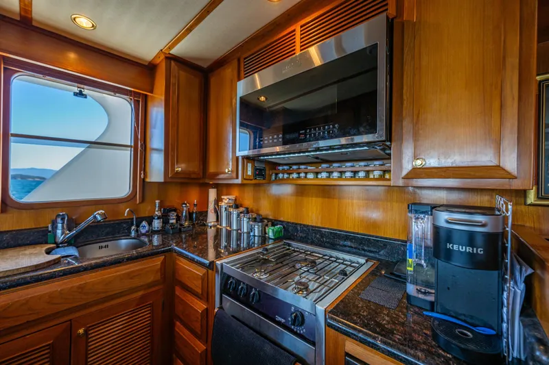Flyin Low Yacht Photos Pics Luxurious 2007 DeFever 56 yacht kitchen with modern appliances and ocean view.
