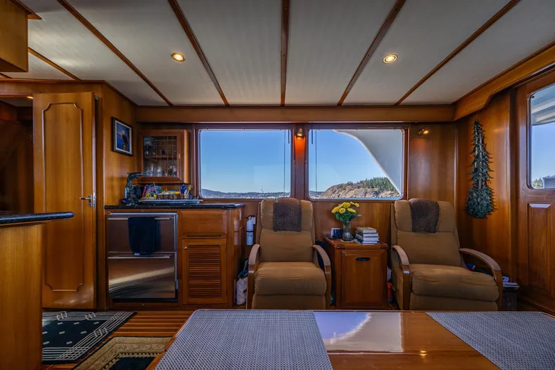 Flyin Low Yacht Photos Pics Luxurious 2007 DeFever 56 yacht interior with plush seating and scenic window views.