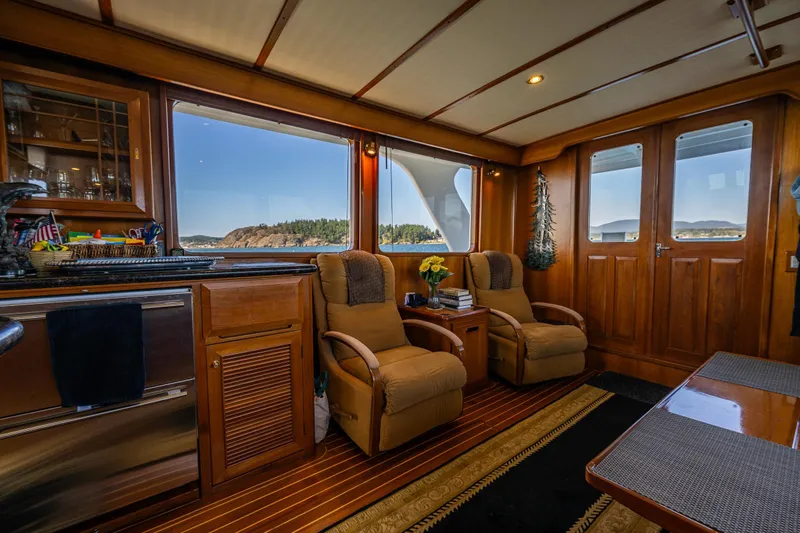 Flyin Low Yacht Photos Pics Luxurious 2007 DeFever 56 yacht interior with plush seating and scenic ocean views.