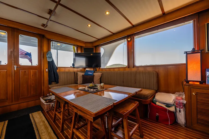 Flyin Low Yacht Photos Pics Luxurious 2007 DeFever 56 yacht interior with elegant wood finish and cozy seating area.