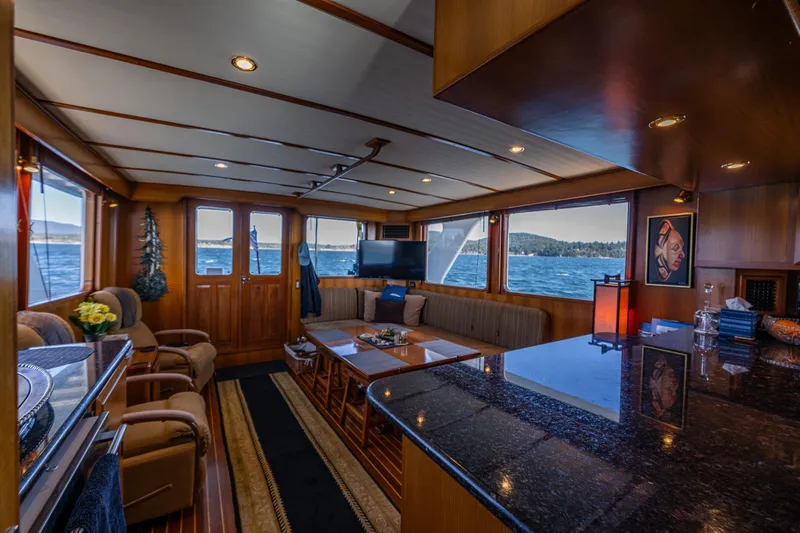 Flyin Low Yacht Photos Pics Luxurious interior of 2007 DeFever 56 yacht with elegant wood finishes and scenic ocean views.