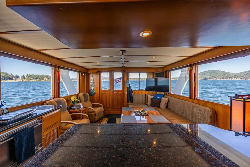 Flyin Low Yacht Photos Pics Luxurious 2007 DeFever 56 yacht interior with panoramic ocean views and elegant wood finishes.