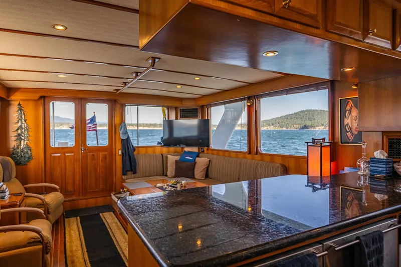 Flyin Low Yacht Photos Pics Luxurious interior of 2007 DeFever 56 yacht with ocean view and elegant wood finishes.