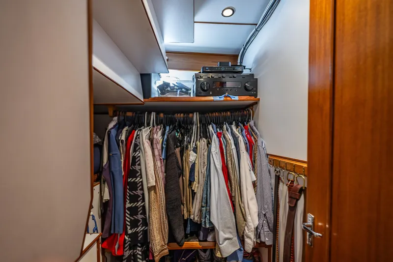 Flyin Low Yacht Photos Pics Closet with clothes and audio equipment in 2007 DeFever 56 yacht interior.
