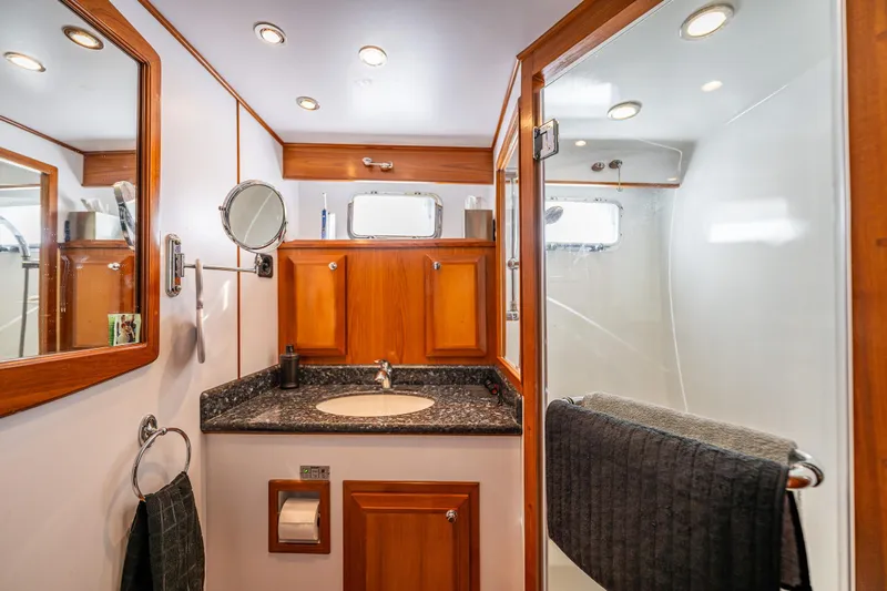 Flyin Low Yacht Photos Pics Luxurious 2007 DeFever 56 yacht bathroom with wood accents and modern fixtures.