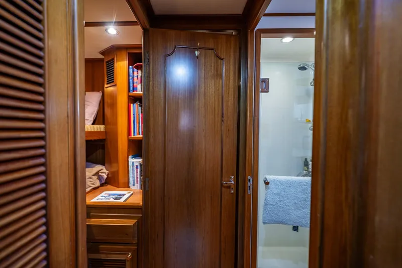 Flyin Low Yacht Photos Pics Interior of 2007 DeFever 56 yacht featuring wooden cabinetry and a bathroom.