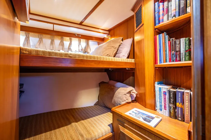 Flyin Low Yacht Photos Pics Cozy cabin with bunk beds and bookshelf on 2007 DeFever 56 yacht.