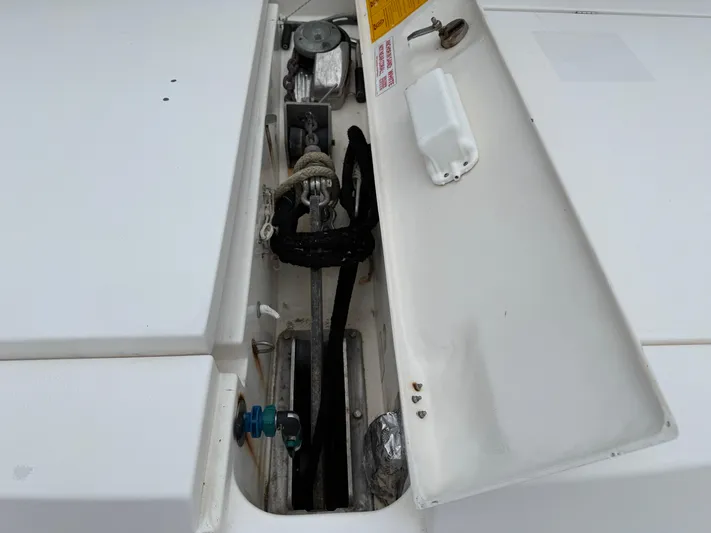 White Wings Yacht Photos Pics Open compartment on a 2013 Leopard 48 yacht, showing mechanical components and ropes.