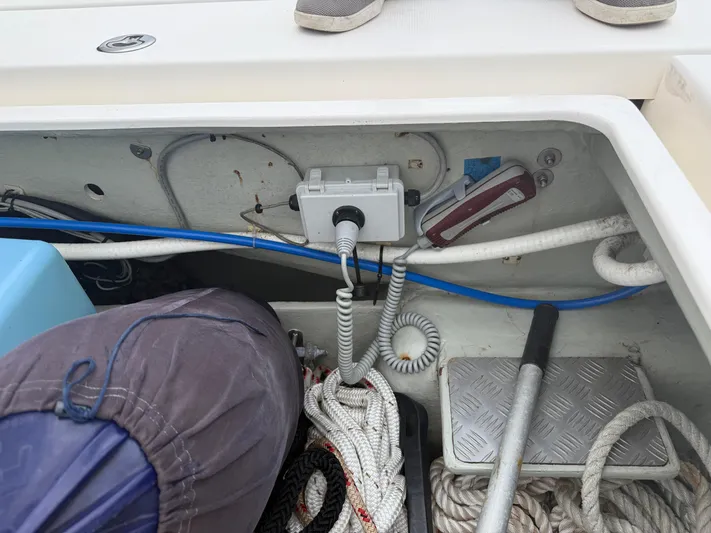 White Wings Yacht Photos Pics Storage compartment on a 2013 Leopard 48 boat with ropes and equipment.